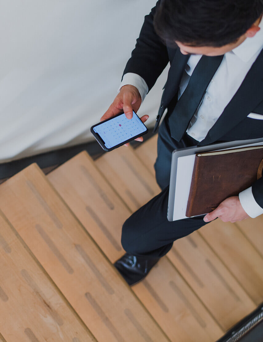 A man in business suit walking up stairs symbolizing progress and professionalism.